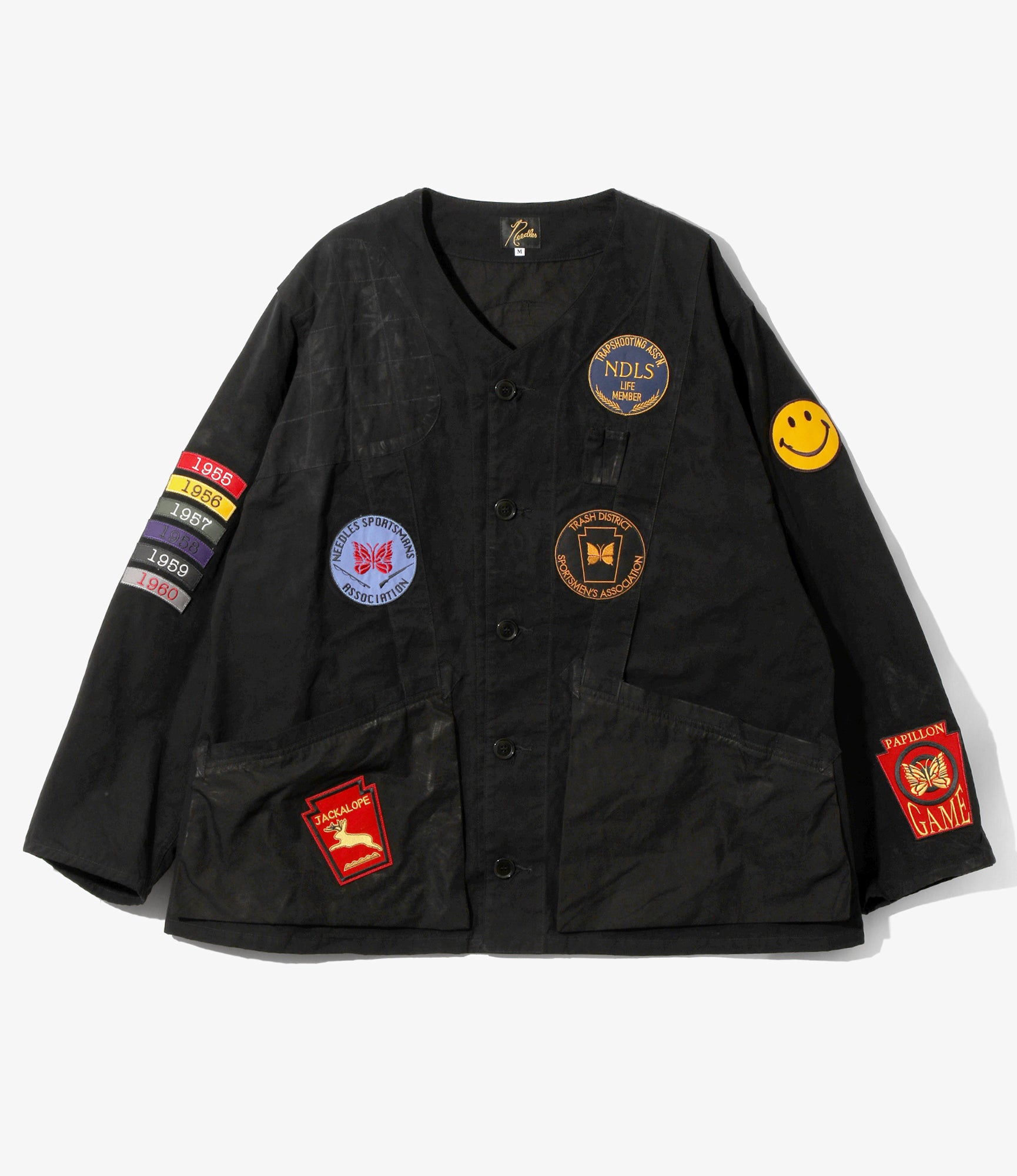 Black jacket with various colorful patches on a white background